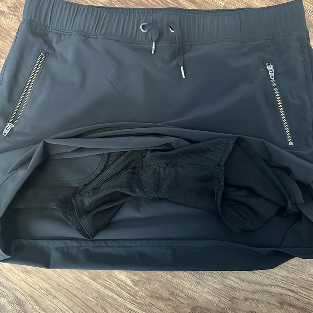 Black Athleta skort with side zipper pockets. - Picture 2 of 6